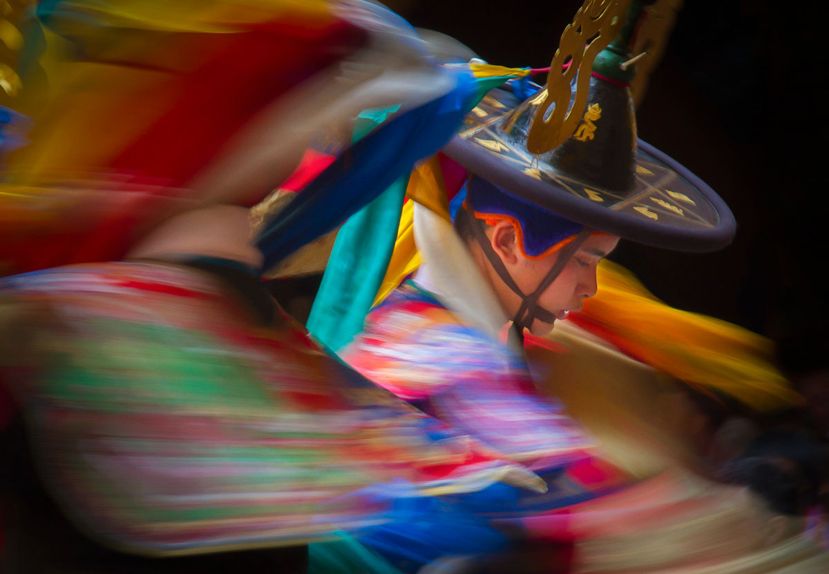 Masked dancers performing in the courtyard of Paro Dzong