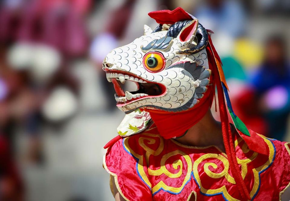 White and red snow lion mask worn by a dancer in eastern Bhutan