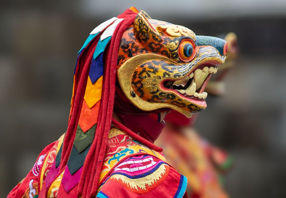 Brightly painted stag mask worn by a dancer at Punakha Dzong