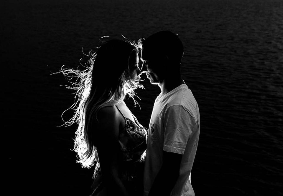 A couple face to face in dramatic black and white light