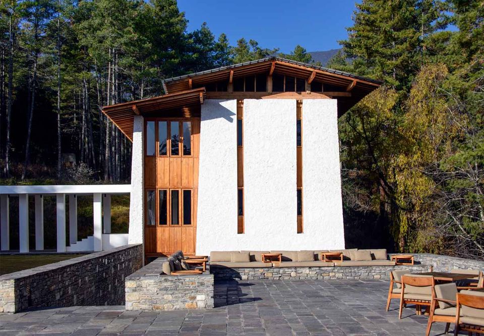 A contemporary Bhutanese lodge with a terrace among pines