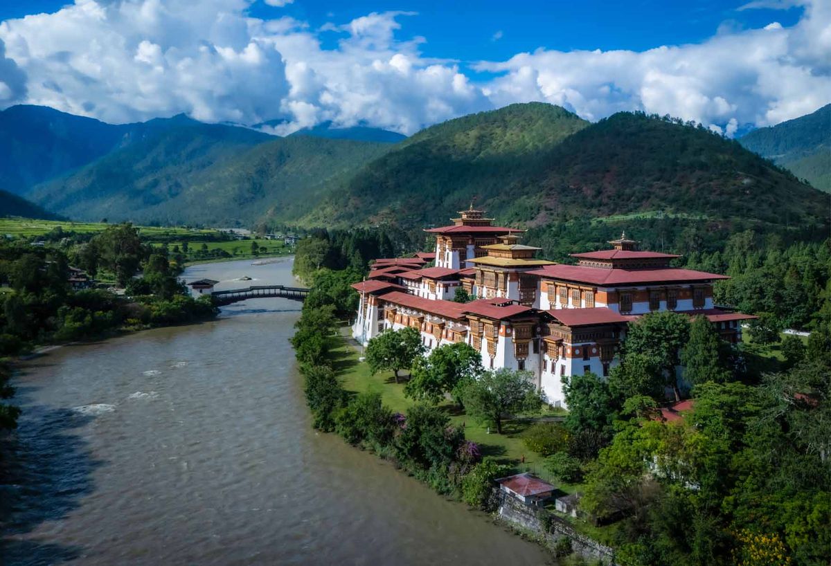 Punakha Dzong at the confluence of two rivers, framed by forested mountains